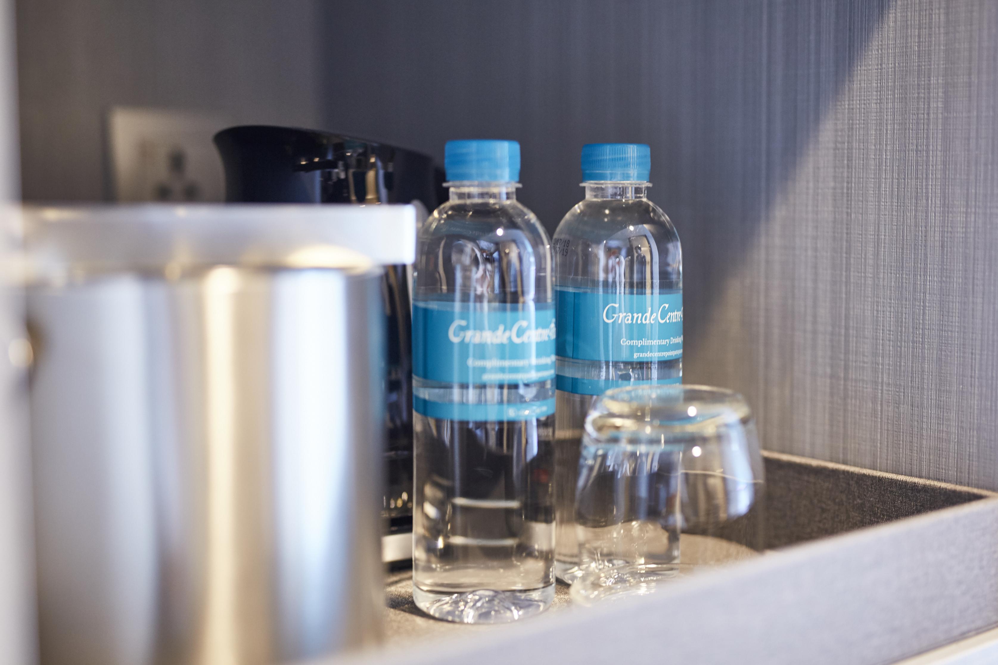 Grande Centre Point Pattaya Hotel Exterior photo Bottled water in a hotel room